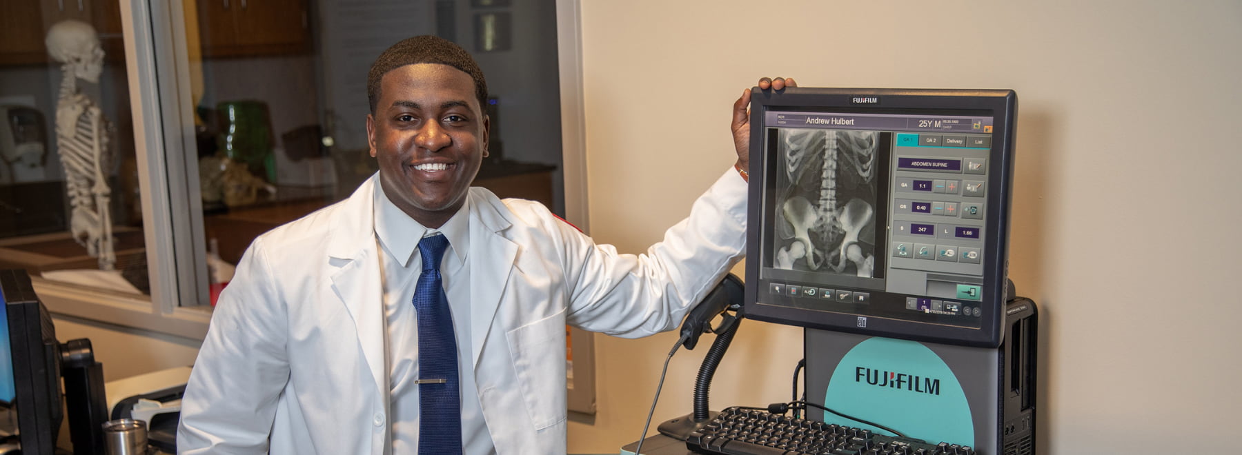 Male radiologic sciences student poses in front of equipment.